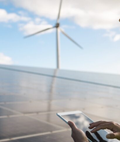Young man working with digital tablet at renewable energy farm - Eco and technology concept - Focus on ear Young man working with digital tablet at renewable energy farm - Eco and technology concept - Focus on ear